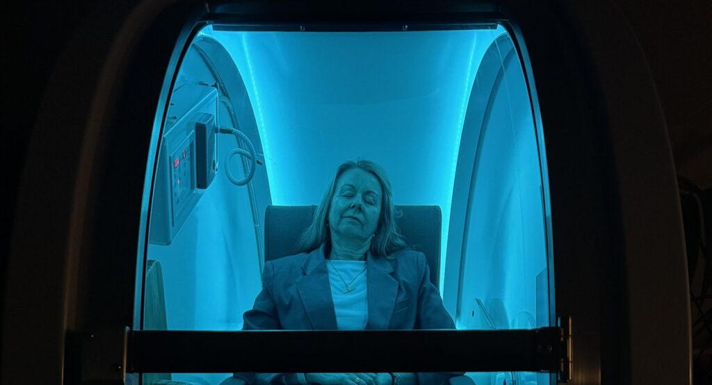 Client in hyperbaric oxygen therapy chamber for fatigue relief at Vital 360 Ballarat